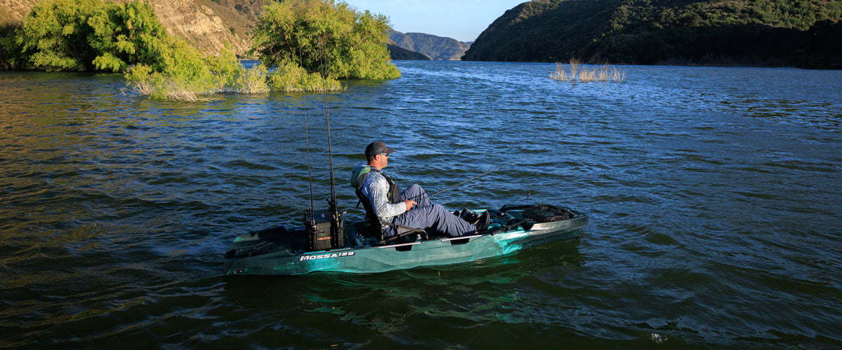 Angler fishing from a MOSSA 128 kayak on a lake — genuine manufacturer photo